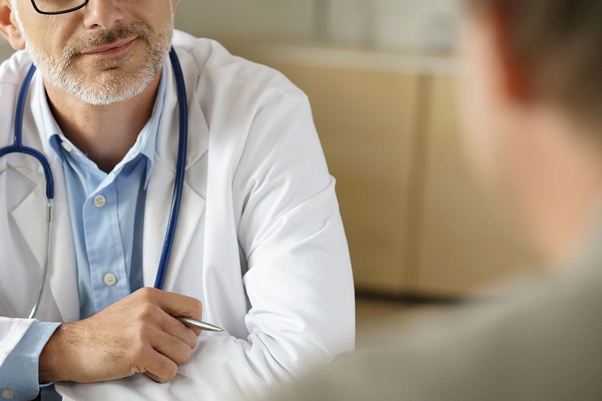 man speaking to a doctor